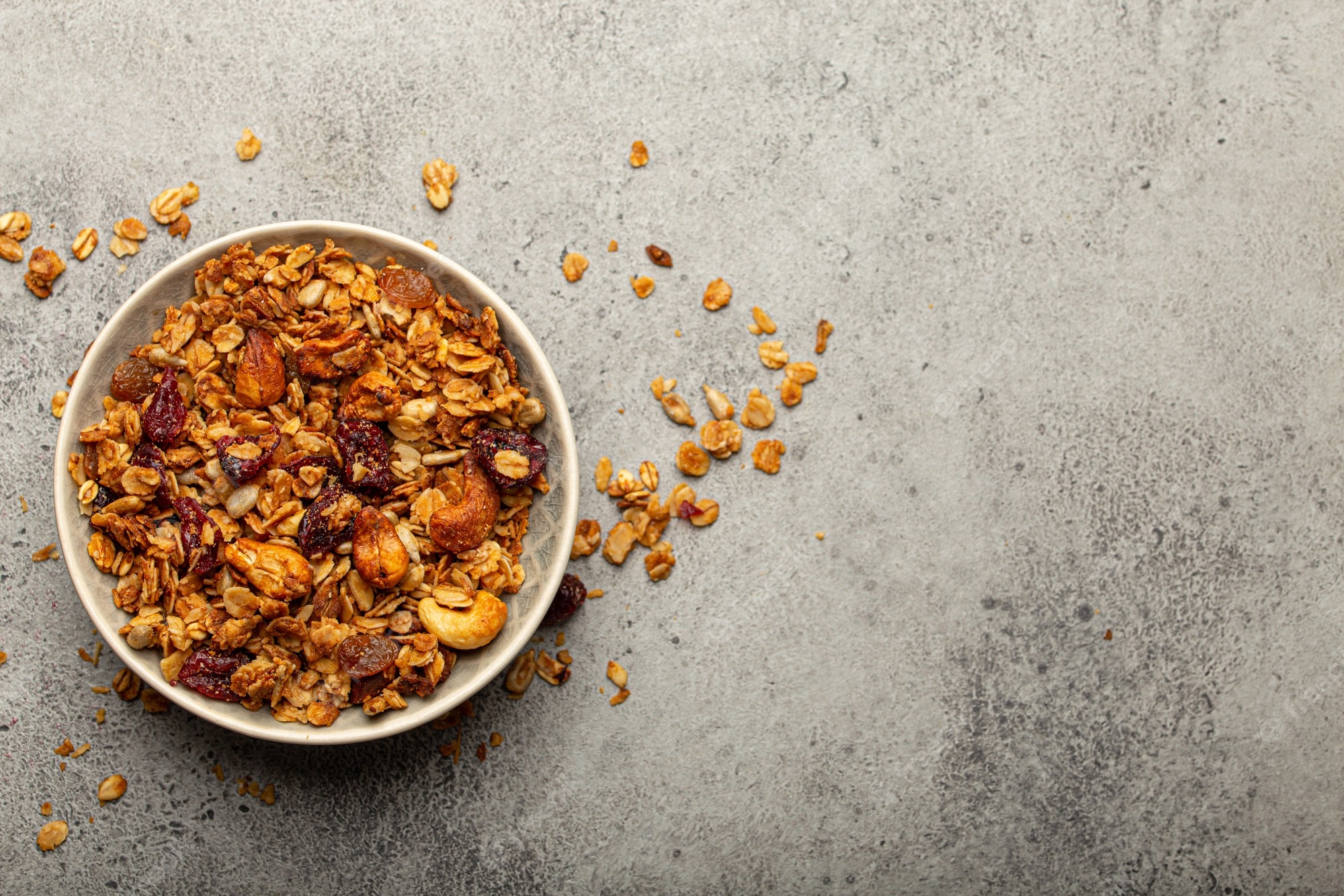 bowl with crispy homemade granola healthy breakfast cereal granola with oatmeal seeds nuts berries rustic stone background from with space text 92134 2487