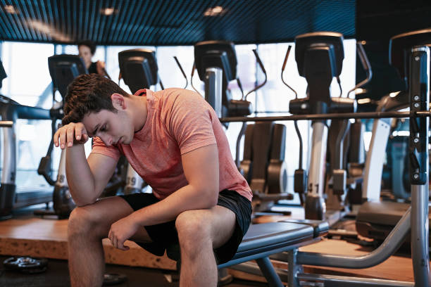 fitness instructor getting tired while working out in health club
