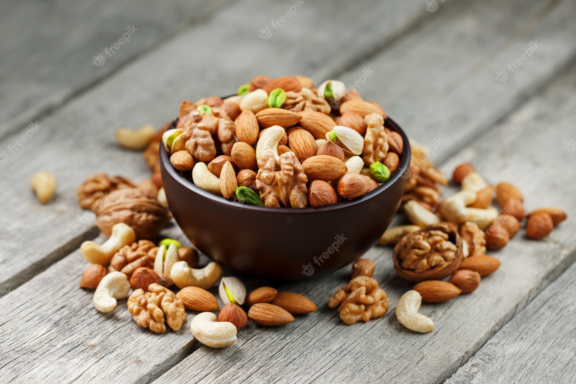 wooden bowl with mixed nuts wooden gray walnut pistachios almonds hazelnuts cashews walnut 94046 1577